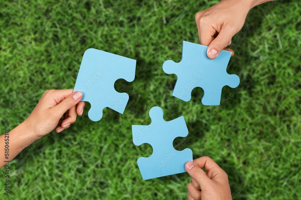 ESG concept of environmental, social, and governance. Hand of people holding a piece of jigsaw puzzl