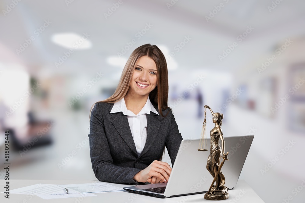 Portrait of young female Lawyer or attorney working in the office, smiling and posing