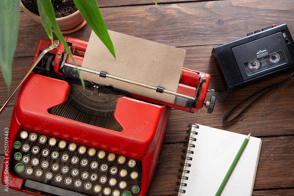 Journalism or blogging concept - vintage typewriter on the wooden desk, top view