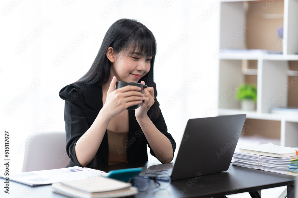 Portrait of Asian young female working on laptop at office