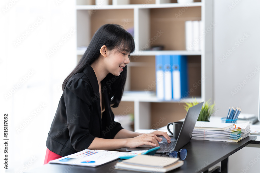 Portrait of Asian young female working on laptop at office