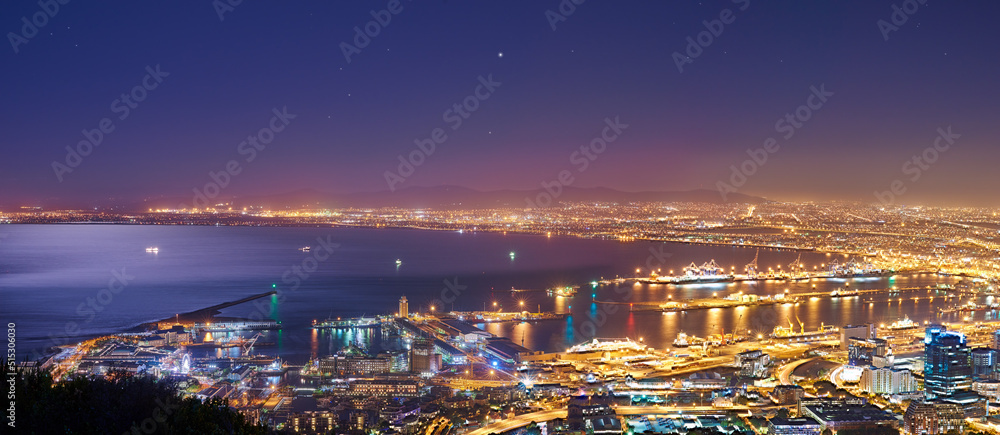 Scenic landscape view of Cape Town city and harbour lit at night after sunset from Signal Hill, Sout