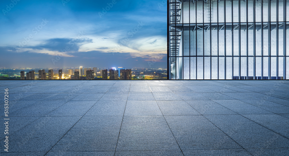 Empty floor and modern city skyline with building scenery at night. high angle view.