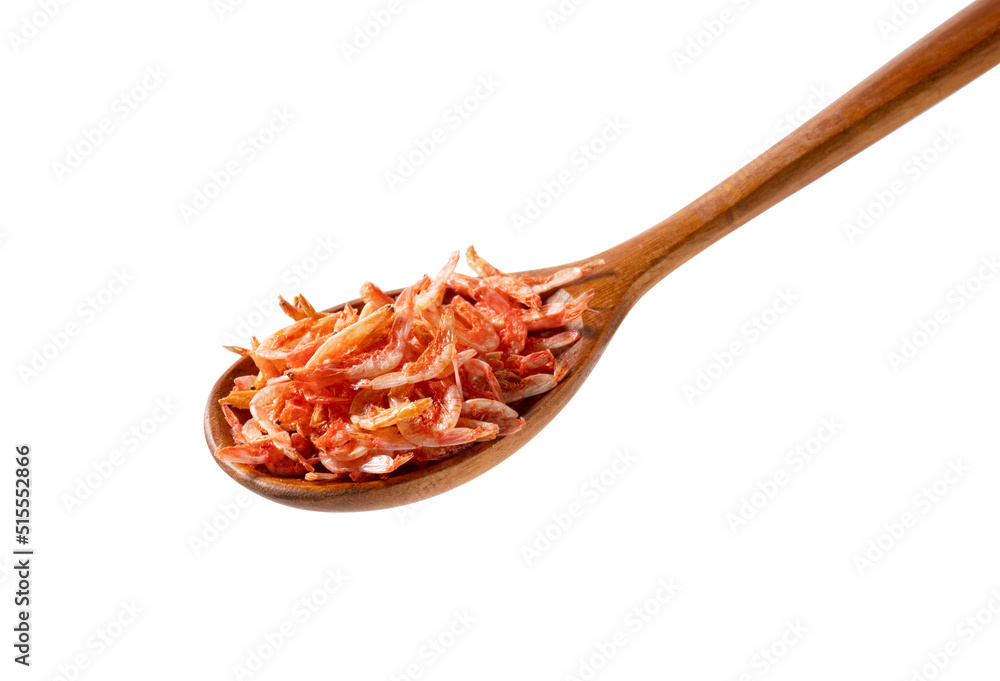 Wooden spoon and dried sakura shrimps on white background.