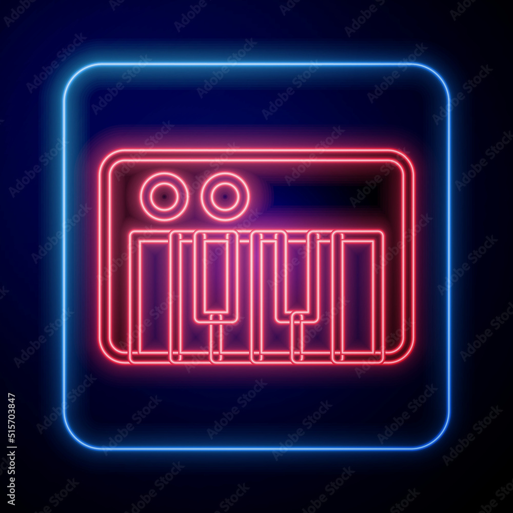 Glowing neon Music synthesizer icon isolated on black background. Electronic piano. Vector