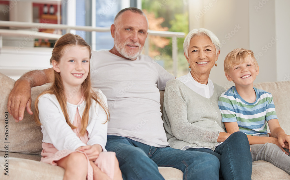 Two siblings relaxing with their grandparents together at home on a couch. Sister and brother visiti