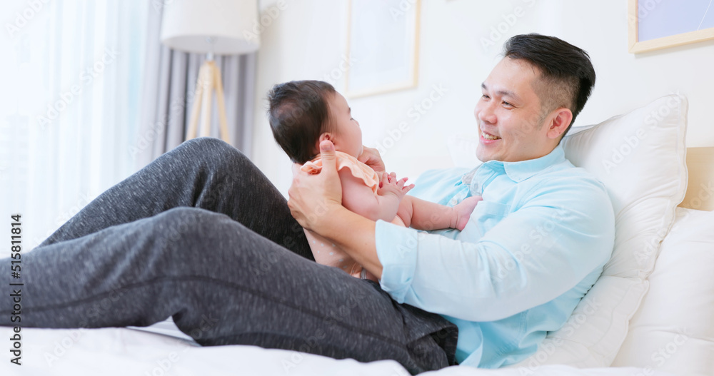 Young father play with baby