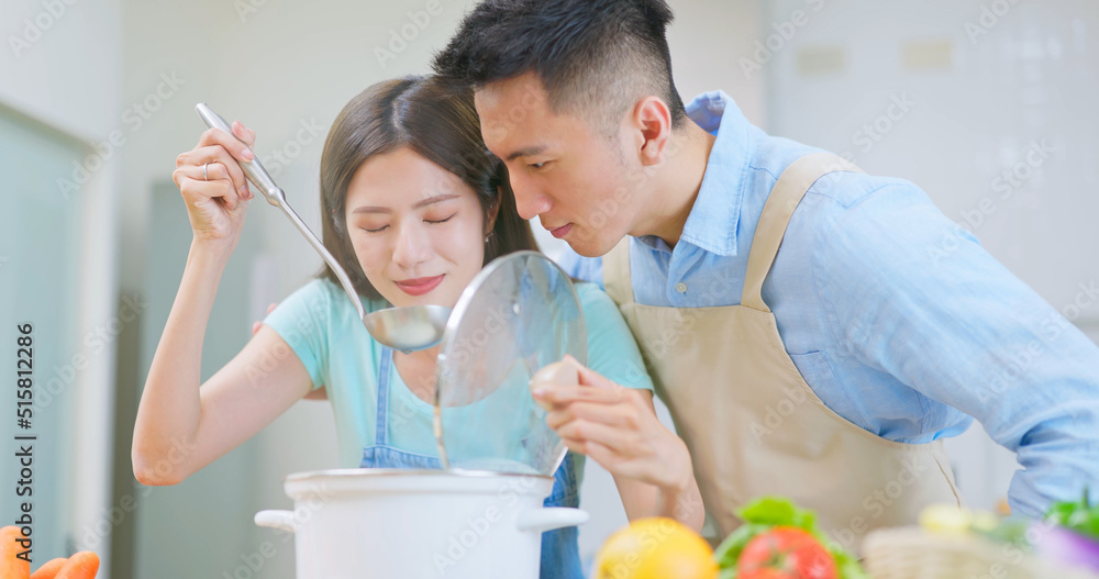 young couple are cooking together