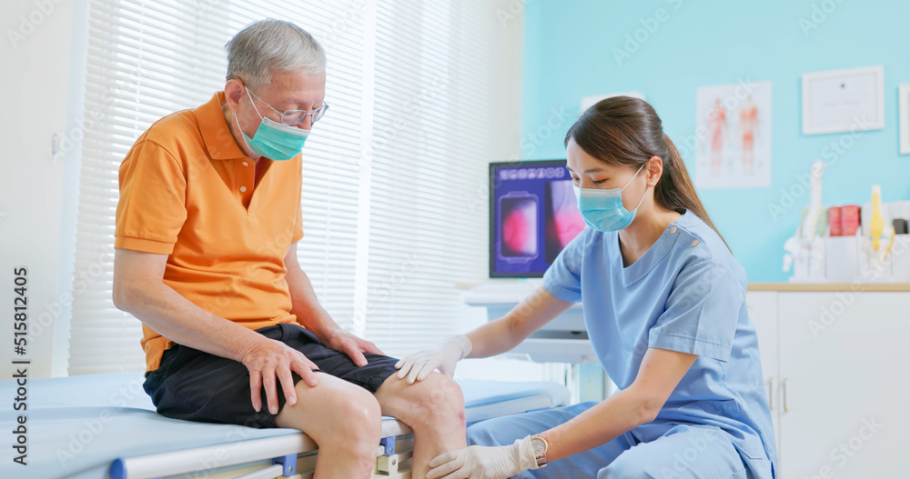 doctor examining patient knee