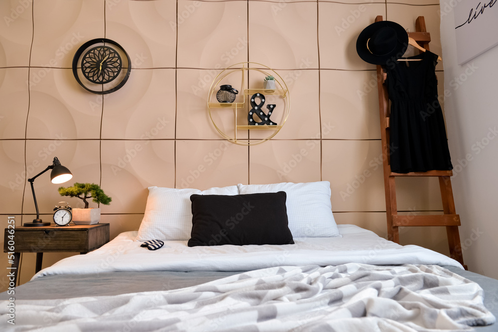 Interior of stylish bedroom with table and wooden ladder