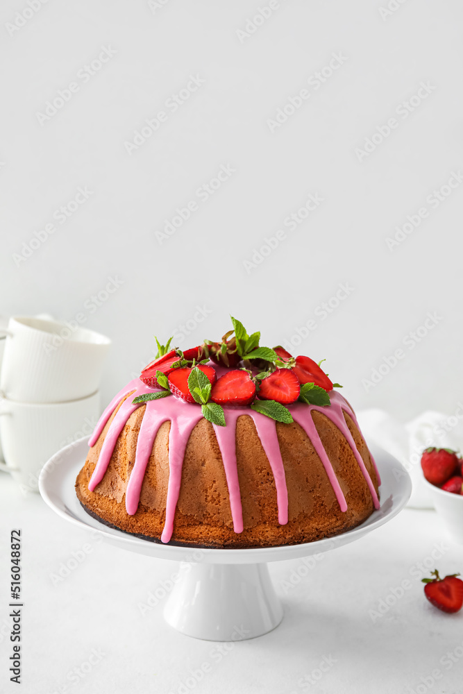 Dessert stand with tasty strawberry cake on table