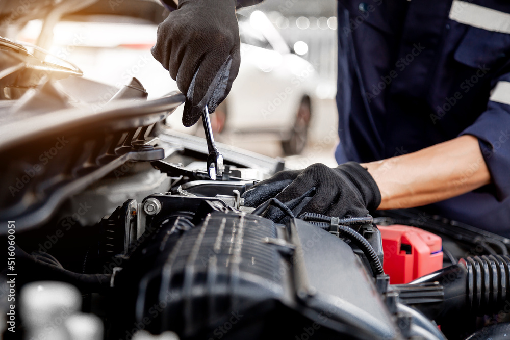 Car care maintenance and servicing, Close-up hand technician auto mechanic using the wrench to repai