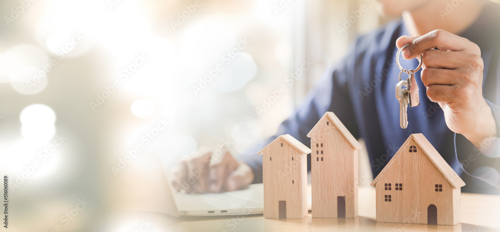 Men holding house model in hand and calculating financial chart for investment to buying property.