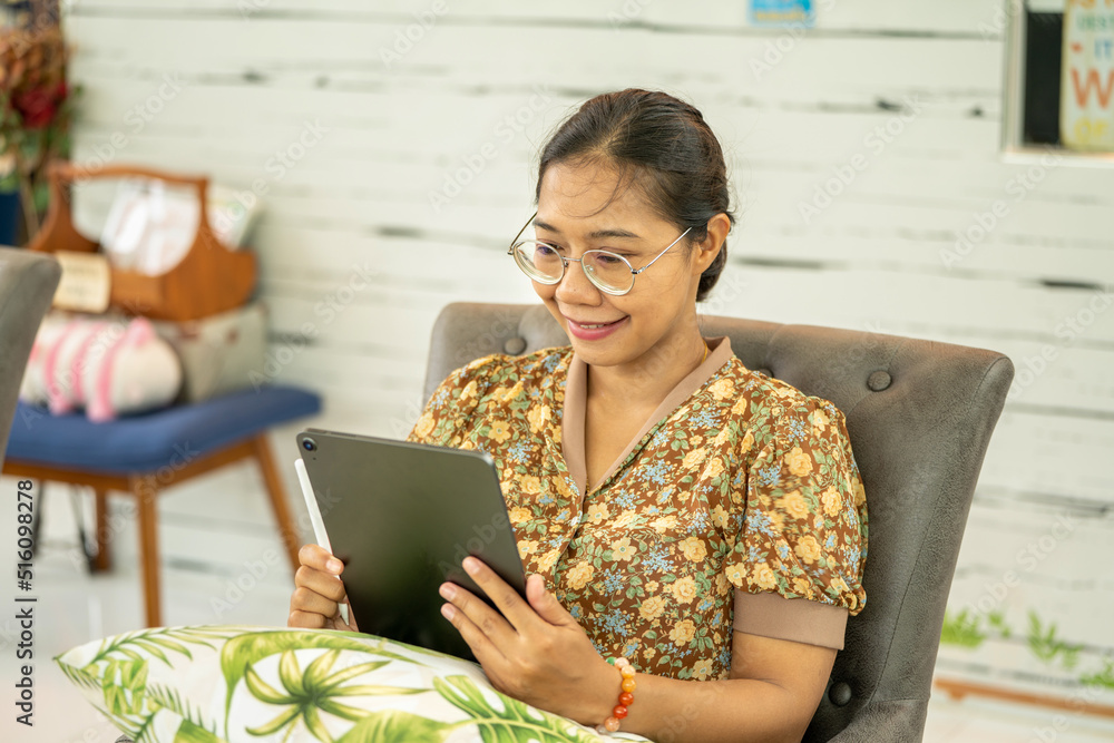 Young woman working with Tablet Laptop at Green house Garden Shop, Digital Nomad woman Remote workin