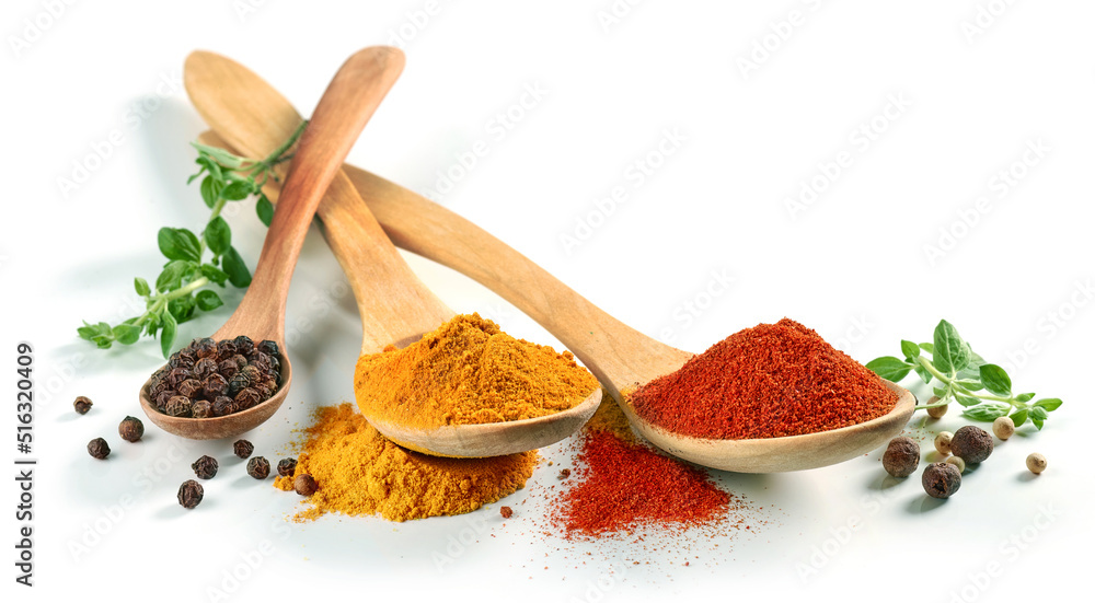 various spices in wooden spoons