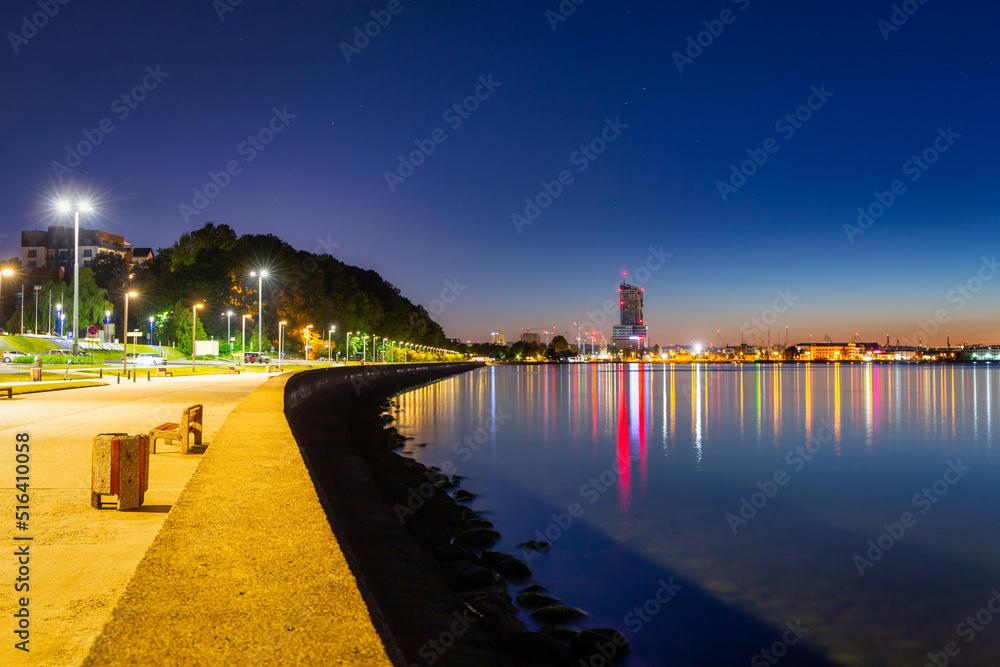 Noctilucent clouds over the Gdynia cityscape at night. Poland