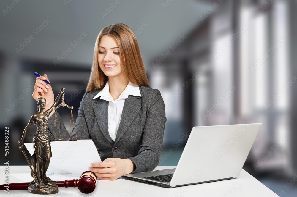 Portrait of young female Lawyer or attorney working in the office, smiling and posing