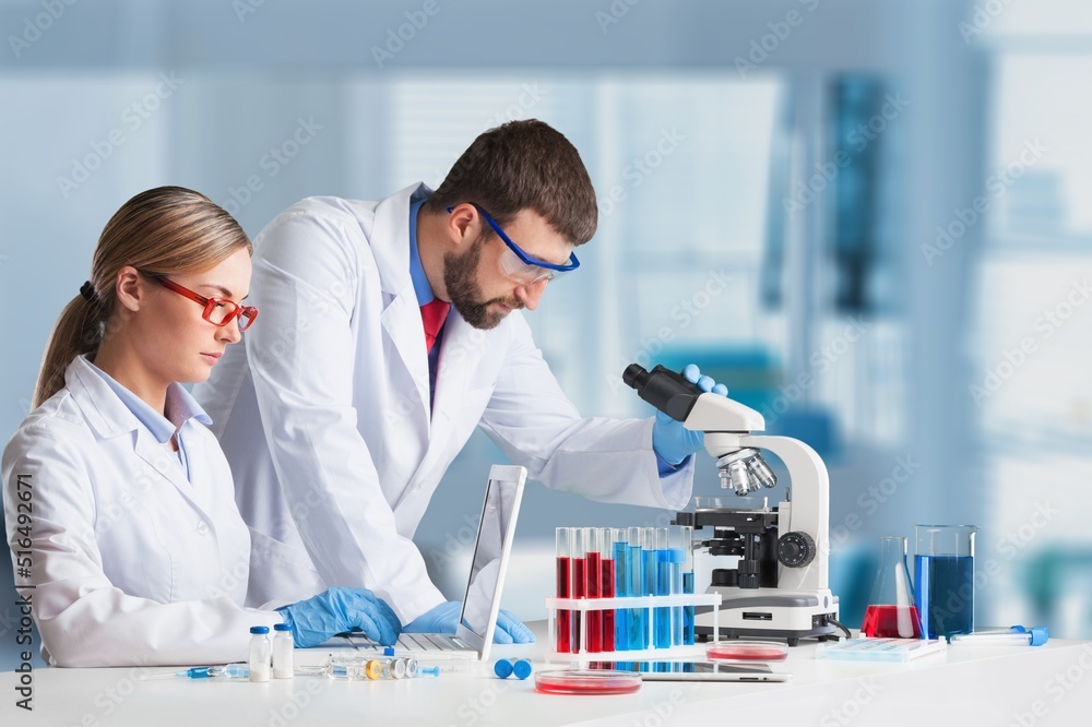 Students working in the clinical laboratory, a researcher is using a microscope, scientific research