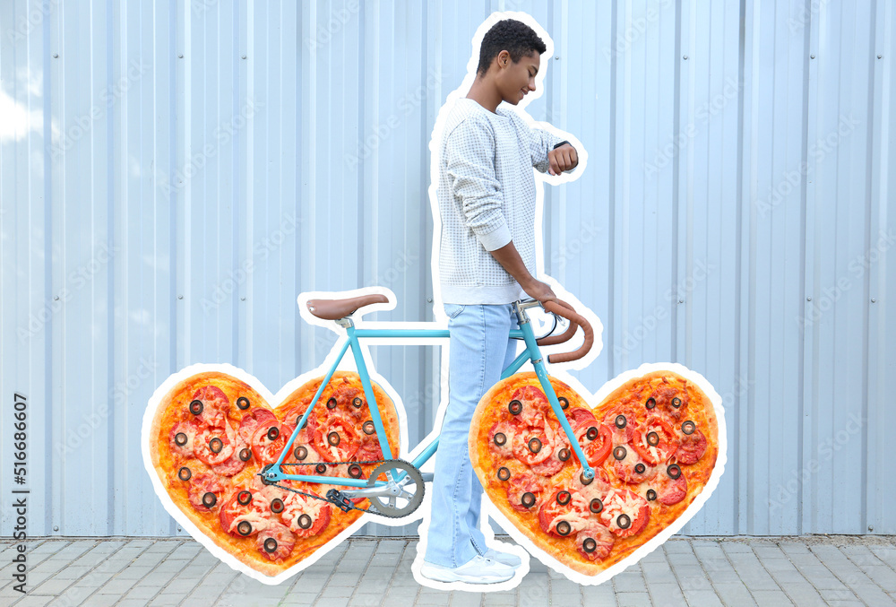 African-American teenage boy and bicycle with heart shaped pizza instead of wheels outdoors