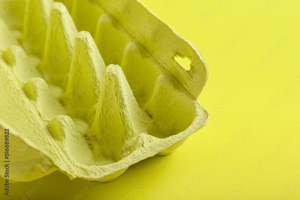 Empty cardboard box for eggs on color background, closeup