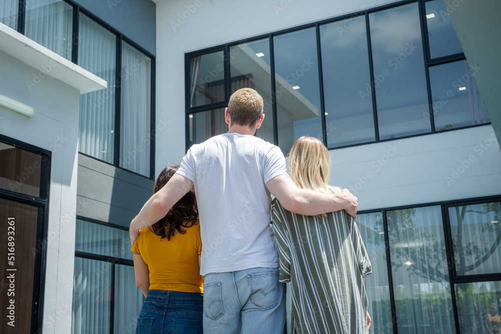 Back view of happy family is happy with their new home.