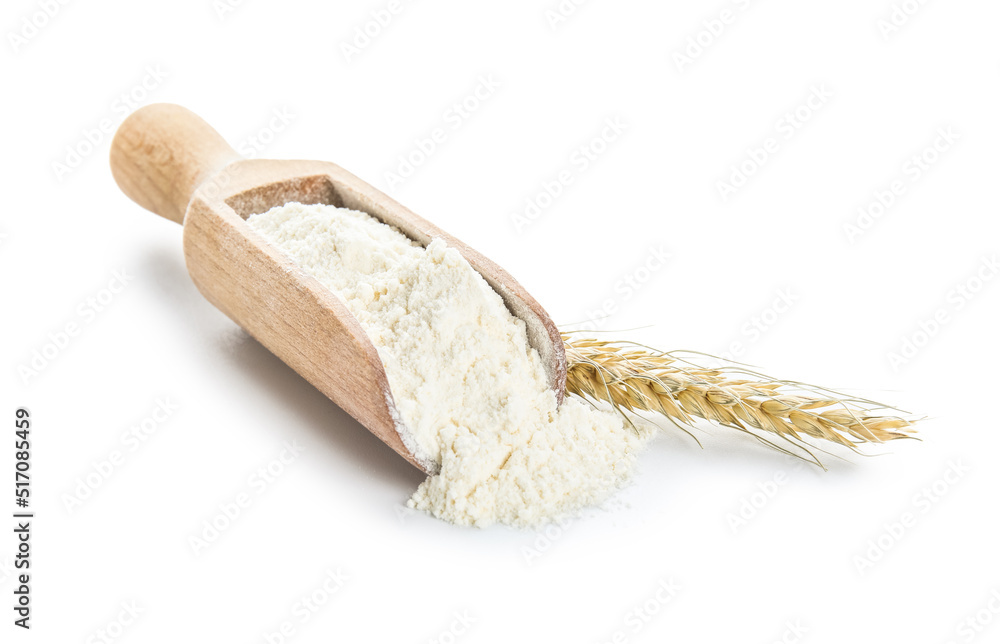 Scoop with flour and wheat ear on white background