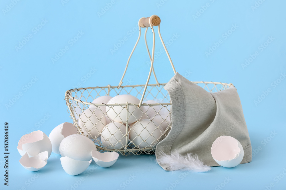 Basket with white chicken eggs on color background