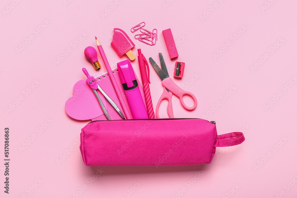 Pencil case with stationery supplies on pink background