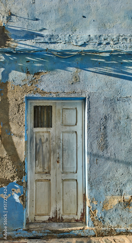 Exterior of a decaying brick building with peeling paint in Santa Cruz de La Palma. Architectural de