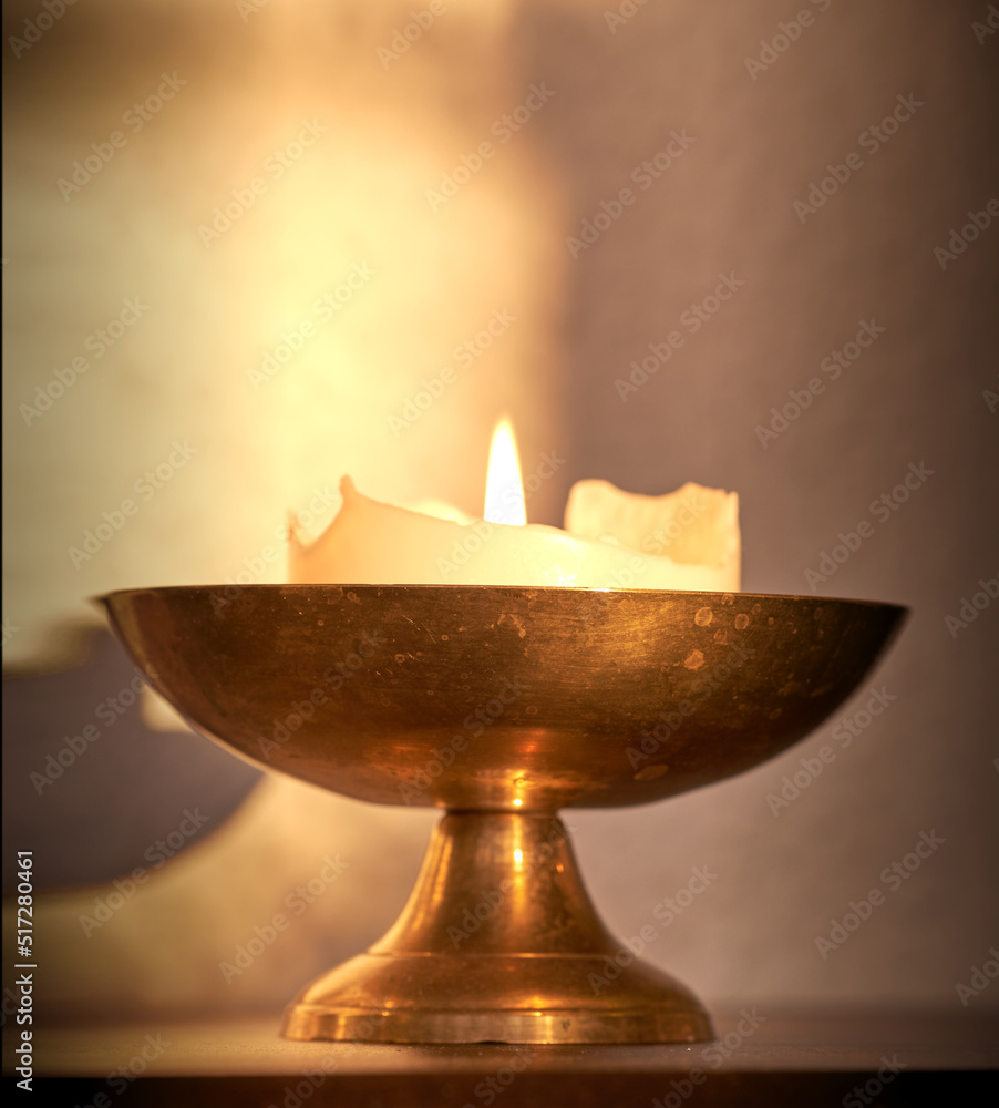 Lit candle on a table at home for warmth and brightness. Beautiful house decoration used for aroma, 