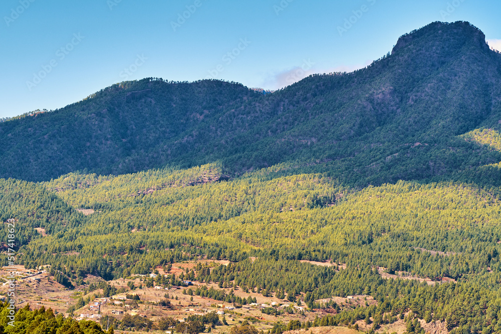 Landscape of mountain pastures in the background of lush forest trees in Spain. City and mountain vi