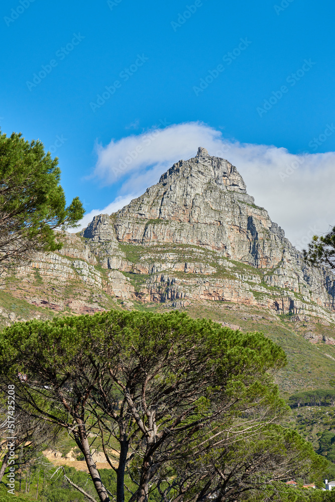 A landscape of a mountain with a cloudy blue sky background and copy space. Peaceful and scenic view