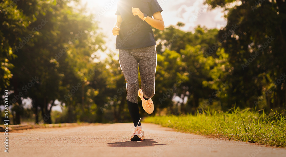 woman runner running on running road in park