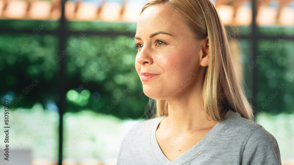 Authentic Portrait of Beautiful Young Female in Kitchen Room at Home Looking Thoughtfully at Her Bac