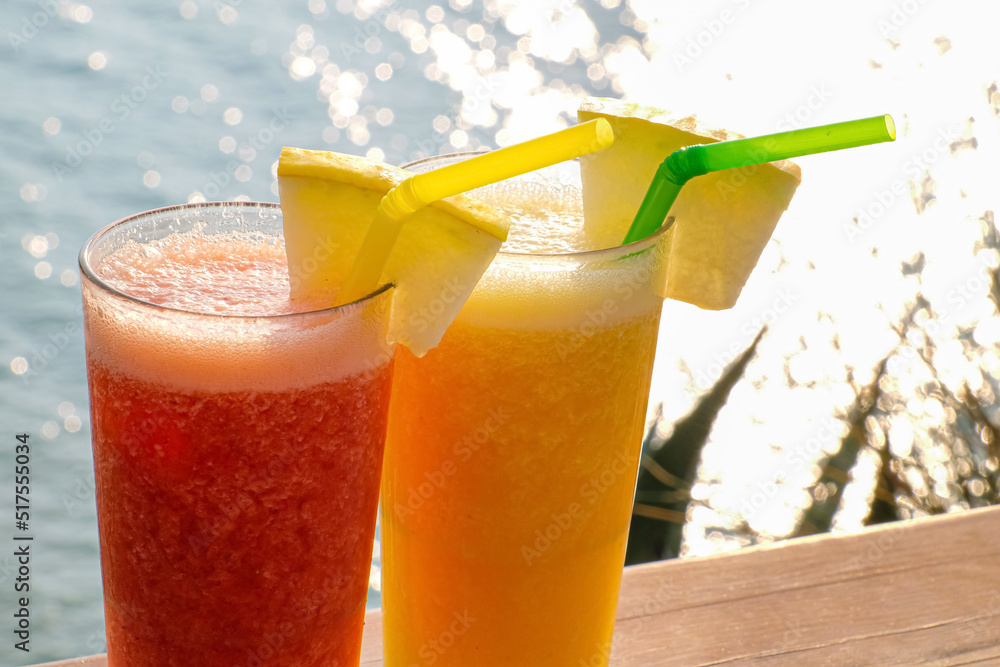 Glasses of fresh tropical cocktail on table at sea resort