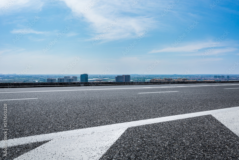 Asphalt road and modern city skyline with building scenery. high angle view.