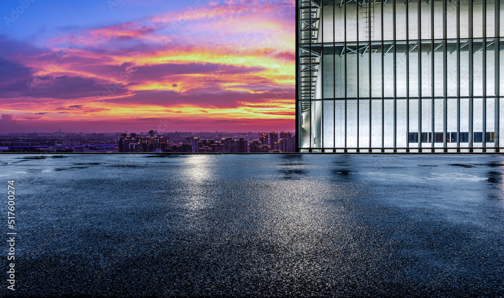 Asphalt road platform and city skyline with sky cloud scenery at sunset