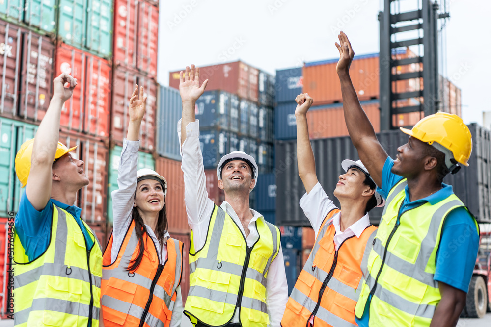 Group of young male and female worker working in container terminal. 