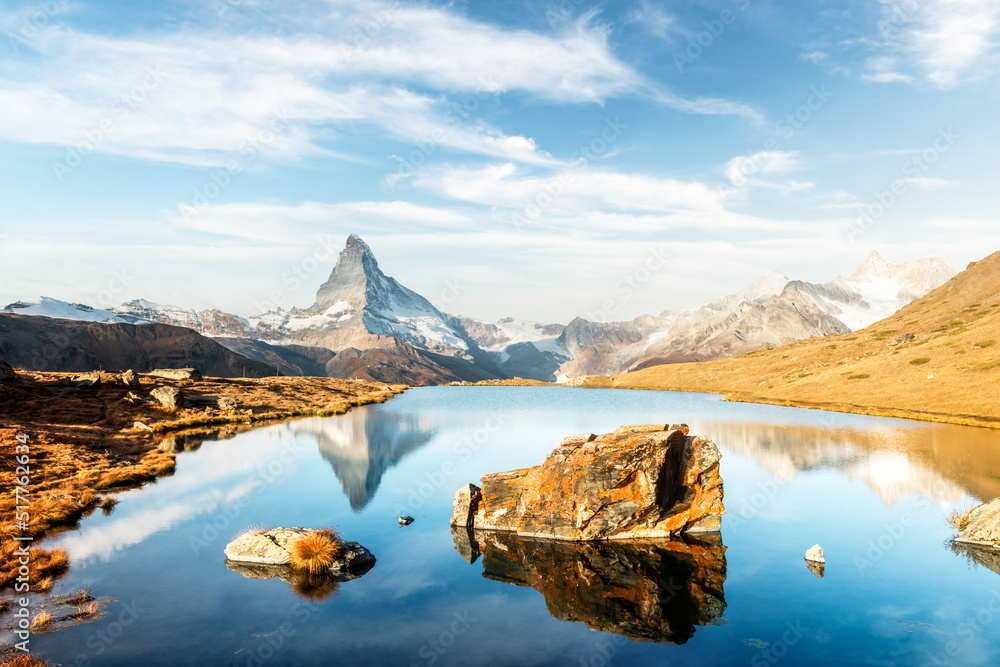 Picturesque landscape with colorful sunrise on Stellisee lake. Snowy Matterhorn Cervino peak with re