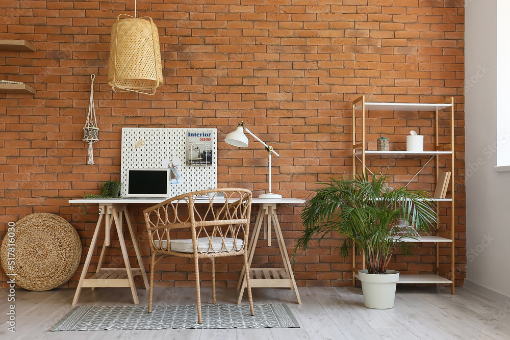 Interior of modern office with workplace, peg board and shelving unit