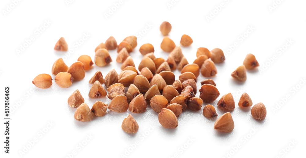 Buckwheat grains scattered on white background