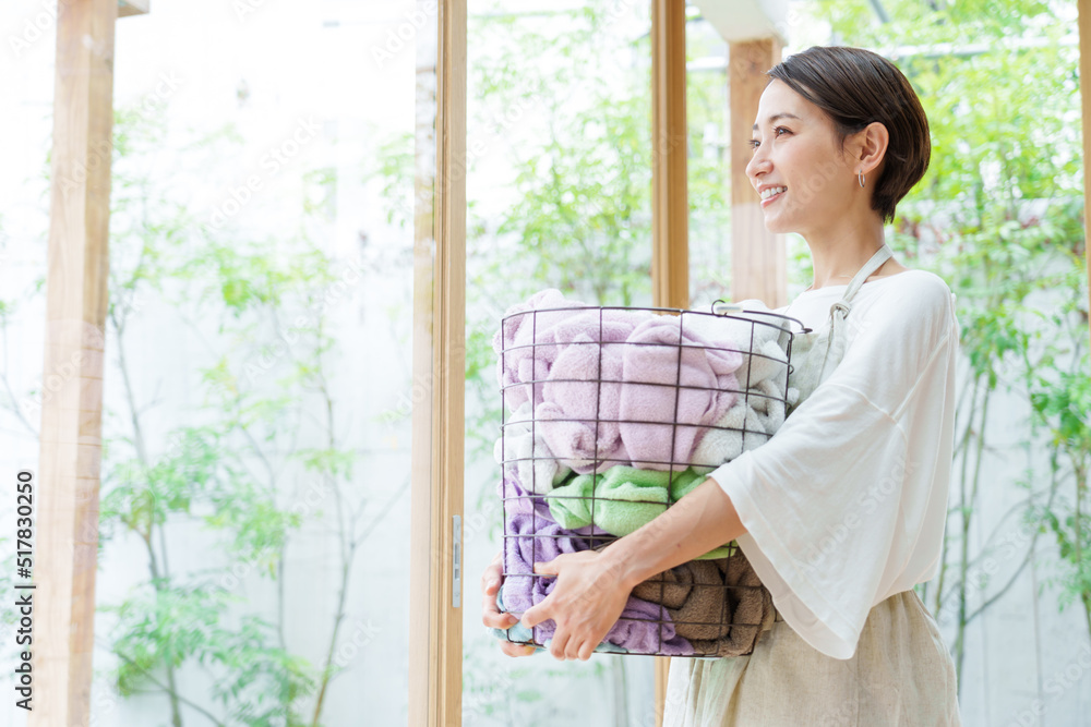 洗濯かごを持つ若い女性