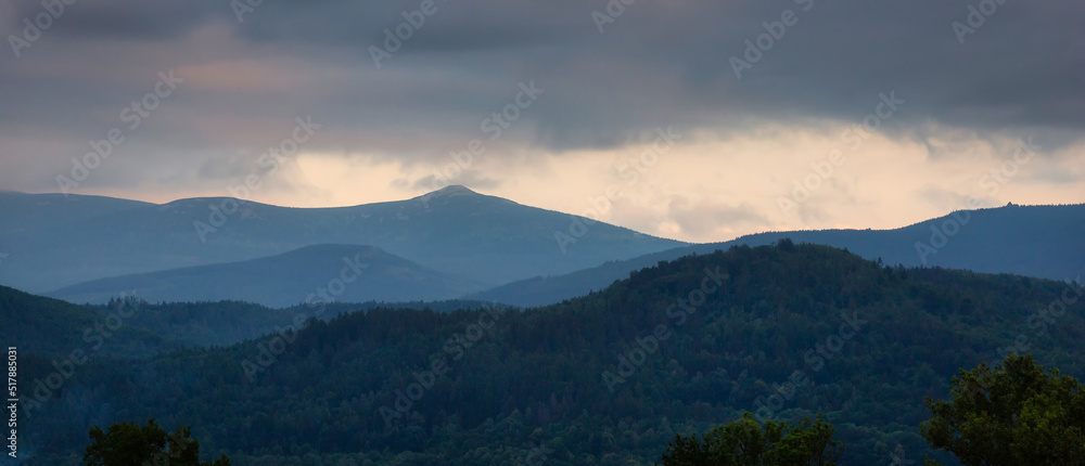 Misty sunset over the Karkonosze Mountains. Poland