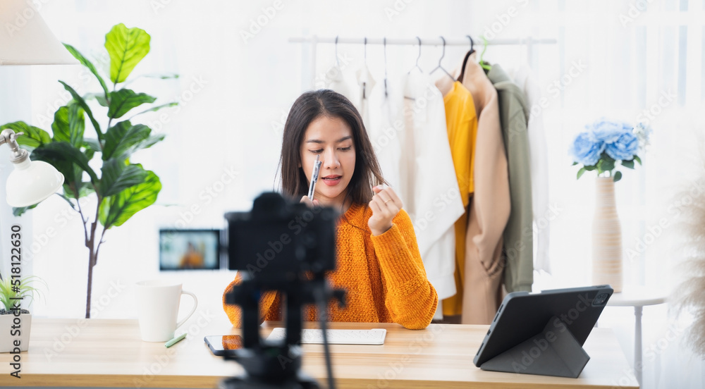 Young Asian woman recording a video for a woman fashion blogger.