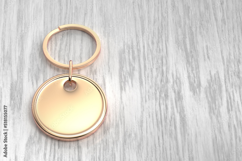 Rose gold round keychain on the wooden table