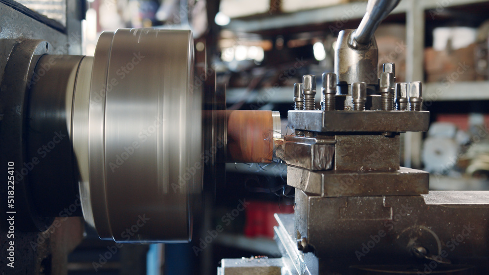 Closeup turning lathe machine operating for metalworking in workshop factory