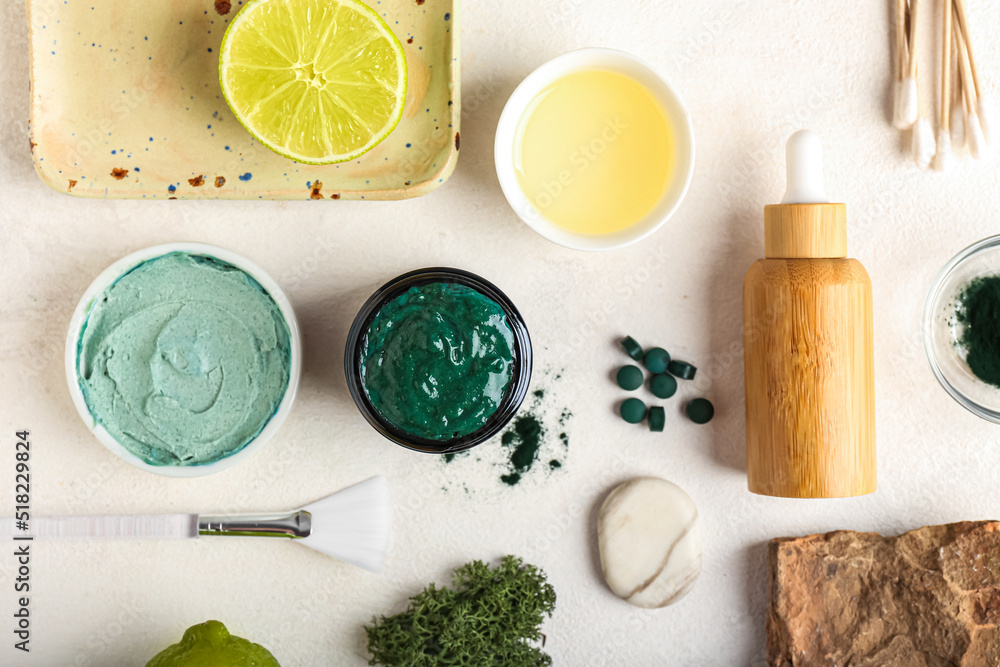 Composition with spirulina facial mask and ingredients on light background