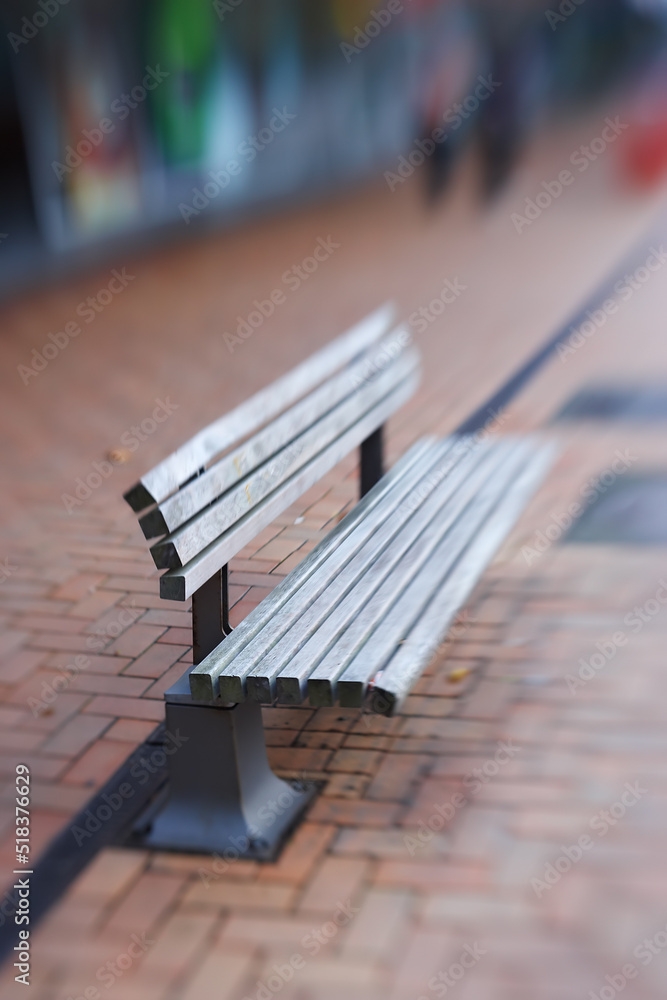 Landscape of empty street bench made of wood. Isolated and weathered outdoor wooden public bench wit