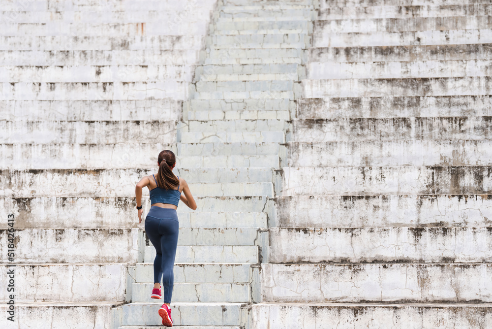 Women are exercising and jogging up the stairs.