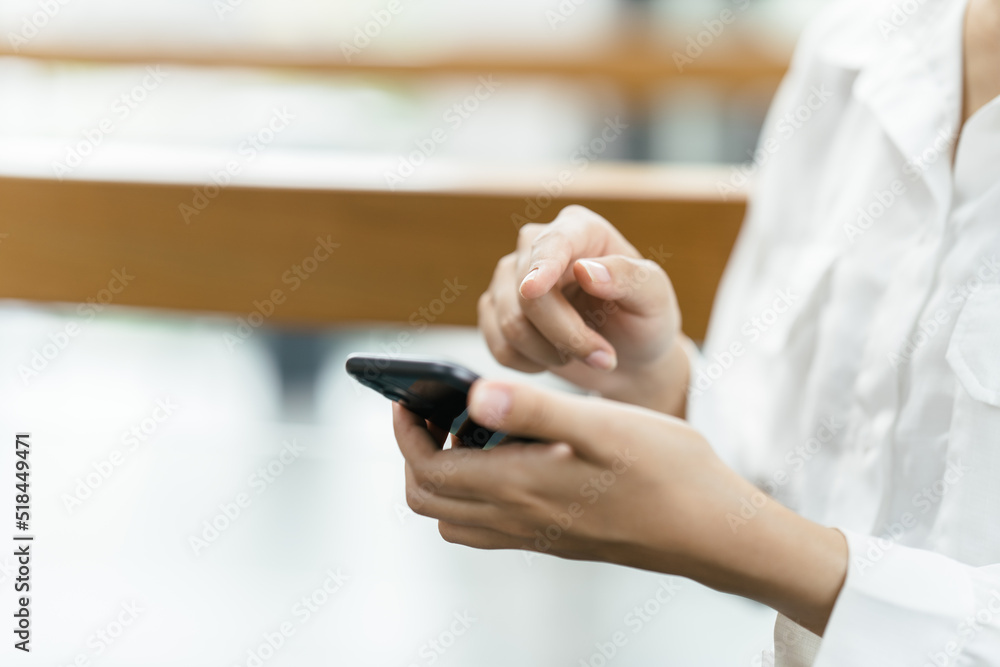 Asian businesswoman in formal suit in office happy and cheerful during using smartphone and working.